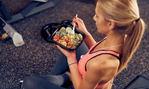 Top,View,Of,Woman,Eating,Healthy,Food,While,Sitting,In